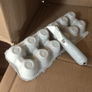 Cardboard, egg crates, and a utility knife can be used to make acoustic shields.